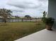 Idyllic backyard view of the pond enhanced by a wrought iron fence and tropical foliage at 10646 Pepper Dawn Cir, San Antonio, FL 33576