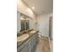 Bathroom featuring double sinks with granite countertops and a glass-enclosed shower at 10646 Pepper Dawn Cir, San Antonio, FL 33576