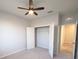 Cozy bedroom featuring a ceiling fan, large closet, and neutral colored carpet at 10646 Pepper Dawn Cir, San Antonio, FL 33576