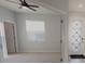 Cozy bedroom featuring neutral carpet, a window with blinds, and an open doorway at 10646 Pepper Dawn Cir, San Antonio, FL 33576