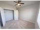 Spacious bedroom featuring a ceiling fan, large closet, and plenty of natural light at 10646 Pepper Dawn Cir, San Antonio, FL 33576