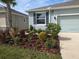 Close-up of the beautifully landscaped front yard with a variety of plants and mulch at 10646 Pepper Dawn Cir, San Antonio, FL 33576