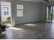 Bright living room with neutral tile flooring and sliding glass doors to backyard at 10646 Pepper Dawn Cir, San Antonio, FL 33576