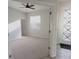 Living room featuring a ceiling fan and a front door entrance at 10646 Pepper Dawn Cir, San Antonio, FL 33576