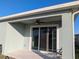 Covered patio featuring ceiling fan and sliding glass doors for seamless indoor-outdoor living at 10646 Pepper Dawn Cir, San Antonio, FL 33576