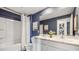 Chic bathroom featuring double vanity, elegant finishes, and ample lighting at 10827 Hidden Banks Gln, Parrish, FL 34219