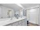 Bright bathroom with double sinks, elegant countertops, and a walk-in shower at 10827 Hidden Banks Gln, Parrish, FL 34219