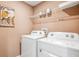 Well-equipped laundry room with modern washer and dryer, offering convenience and efficiency at 10827 Hidden Banks Gln, Parrish, FL 34219