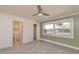 Bright bedroom featuring a ceiling fan, tiled floors, and a window with natural light at 10829 65Th N Way, Pinellas Park, FL 33782