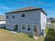 View of the back of the house showing the patio, yard, and exterior paint at 11333 June Briar Loop, San Antonio, FL 33576