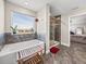 Well-lit bathroom with large window over the soaking tub and separate glass shower at 11333 June Briar Loop, San Antonio, FL 33576