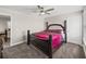 Spacious carpeted bedroom with a grand bed and an open doorway to the dining area at 11333 June Briar Loop, San Antonio, FL 33576