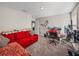 Carpeted bedroom featuring a red couch, gaming computer, and multiple monitors at 11333 June Briar Loop, San Antonio, FL 33576