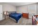 Comfortable bedroom with plush carpet, a full-size bed, and a changing table at 11333 June Briar Loop, San Antonio, FL 33576