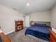 Cozy bedroom with plush carpet, natural light, a bookcase, and queen-size bed at 11333 June Briar Loop, San Antonio, FL 33576