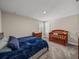 Bedroom featuring carpeted floors, a changing table, crib, and neutral color palette at 11333 June Briar Loop, San Antonio, FL 33576