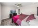 Bedroom featuring carpeted floors, a large bed, and a view of a television at 11333 June Briar Loop, San Antonio, FL 33576