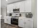 Bright kitchen with stainless steel appliances, white cabinetry, and ample countertop space for meal preparation at 11333 June Briar Loop, San Antonio, FL 33576