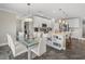 A open-concept kitchen and dining area features white cabinets, an island, and stainless steel appliances at 11333 June Briar Loop, San Antonio, FL 33576