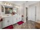 Main bathroom featuring double sinks, stylish shower with glass door and a separate water closet at 11333 June Briar Loop, San Antonio, FL 33576