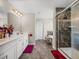 Main bathroom featuring double sinks, stylish shower with glass door and a separate soaking tub at 11333 June Briar Loop, San Antonio, FL 33576