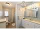 Well-lit bathroom featuring a vanity with storage, a mirror, and a toilet at 114 W Saint Johns Way, Apollo Beach, FL 33572