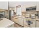 Functional kitchen featuring stainless steel appliances, white cabinetry, and lots of counter space at 114 W Saint Johns Way, Apollo Beach, FL 33572