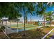 Community shuffleboard court shaded by mature palm trees at 114 W Saint Johns Way, Apollo Beach, FL 33572