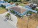 An aerial view of a single Gathering home with a circular driveway and well manicured landscaping at 1211 Carolyn Ln, Clearwater, FL 33755