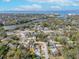 Sweeping aerial view of charming neighborhood, showcasing proximity to the water and serene, tree-lined streets at 1211 Carolyn Ln, Clearwater, FL 33755