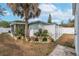 Fully fenced backyard showcases mature landscaping and a charming shed providing ample storage at 1211 Carolyn Ln, Clearwater, FL 33755