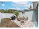 Backyard patio area, with a firepit, seating and grill, offers great space to enjoy the outdoors at 1211 Carolyn Ln, Clearwater, FL 33755