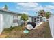 A backyard featuring a patio with chairs, a grill, and a screened in lanai at 1211 Carolyn Ln, Clearwater, FL 33755