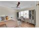 Bedroom with a ceiling fan, light colored walls and floors, and modern decor at 1211 Carolyn Ln, Clearwater, FL 33755