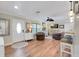 Bright and airy living room with natural light, featuring elegant decor, hardwood floors, and comfortable leather seating at 1211 Carolyn Ln, Clearwater, FL 33755