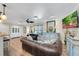 Comfortable living room showcasing hardwood floors, a stylish hutch, and views into the kitchen and dining area at 1211 Carolyn Ln, Clearwater, FL 33755