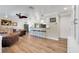 Spacious living room featuring hardwood floors and a breakfast bar that connects to the modern kitchen at 1211 Carolyn Ln, Clearwater, FL 33755