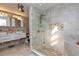 Bright bathroom with tiled shower and dual vessel sinks on floating vanity at 12478 93Rd Way, Largo, FL 33773