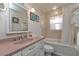 Traditional bathroom includes a vanity, mirror, framed artwork, and a tub with a shower at 12478 93Rd Way, Largo, FL 33773