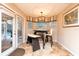 Bright breakfast nook featuring an elegant chandelier, tile floor and view of the pool at 12478 93Rd Way, Largo, FL 33773