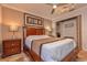 Comfortable main bedroom featuring a ceiling fan, a wooden bed frame, bedside lamps, and a closet at 12478 93Rd Way, Largo, FL 33773