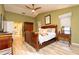 Spacious main bedroom featuring wood floors, a ceiling fan, and a walk-in bathroom at 12478 93Rd Way, Largo, FL 33773