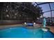 Enjoy the evening in this screened pool and spa with attractive lighting and a relaxing waterfall feature at 12478 93Rd Way, Largo, FL 33773