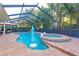 Screened pool with a jacuzzi, surrounding patio, and tropical landscaping at 12478 93Rd Way, Largo, FL 33773