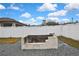 Outdoor stone and brick firepit surrounded by gravel in a fenced-in backyard at 12704 Vander Way, New Port Richey, FL 34654