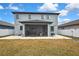 View of the home's back exterior with a screened in lanai and outdoor patio at 12704 Vander Way, New Port Richey, FL 34654