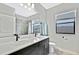 Modern bathroom featuring double sinks, quartz countertops, tile shower, and a bright window for natural light at 12704 Vander Way, New Port Richey, FL 34654