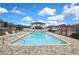 Clean community pool with tiled edges and safety features in a residential neighborhood at 12704 Vander Way, New Port Richey, FL 34654