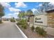 Sign for Rose Haven community with stone accents and lush landscaping at 12704 Vander Way, New Port Richey, FL 34654