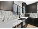 Close-up of a modern kitchen sink with stainless steel appliances and stylish backsplash tiles at 12704 Vander Way, New Port Richey, FL 34654